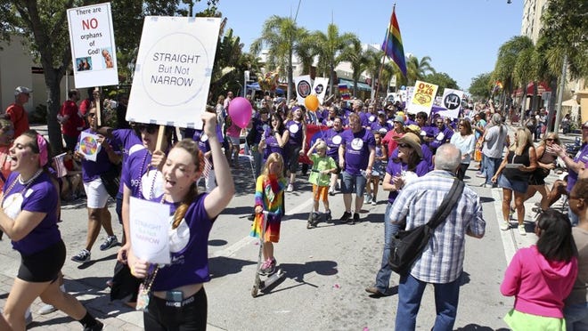 Members of the Metropolitan Community Church of the Palm Beaches parade down Lake Avenue during PrideFest celebrations in Lake Worth on Sunday, March 29, 2015. (Madeline Gray / The Palm Beach Post)