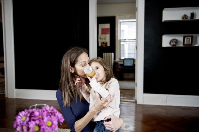 Christine Salerno holds her daughter, Lily, 4, at home in Brookly, N.Y. A rare neurological disorder has mildly hampered Lily's development, and Salerno has learned how overwhelming it can be to financially plan for special needs children. "She has 10 therapists and 15 doctors, and I manage all of this,"? Salerno said.