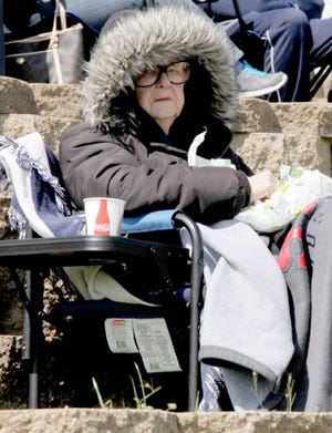 Jamie Mitchell • Times Record - Mary Beth Sudduth tries keeping warm Saturday, March 28, 2015, during the University of Arkansas at Fort Smith Lions baseball game against Rogers State at Crowder Field.