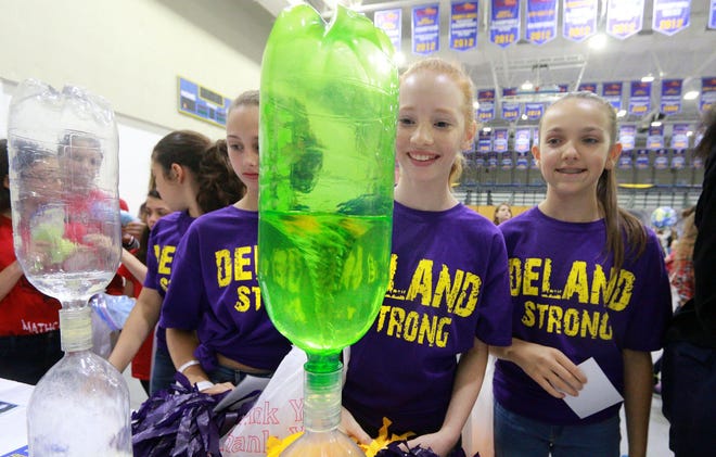 Students Caroline Champaige, left, Avery Harris, and Kaylee Perkins from DeLand Middle School check out a water tornado they made during Embry-Riddle Aeronautical University’s Women in Aviation Day held Tuesday at the ICI Center in Daytona Beach.