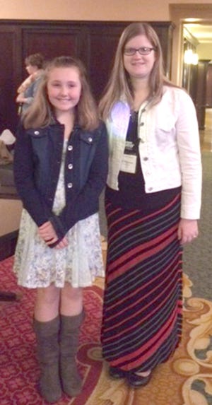 Delani Monahan and family (not pictured) and her teacher, Emily Bechstein, traveled to Grand Rapids for the Kaleidoscope Awards. Bechstein entered Delani's short story in December 2014, and it was selected for an award in February. COURTESY PHOTO
