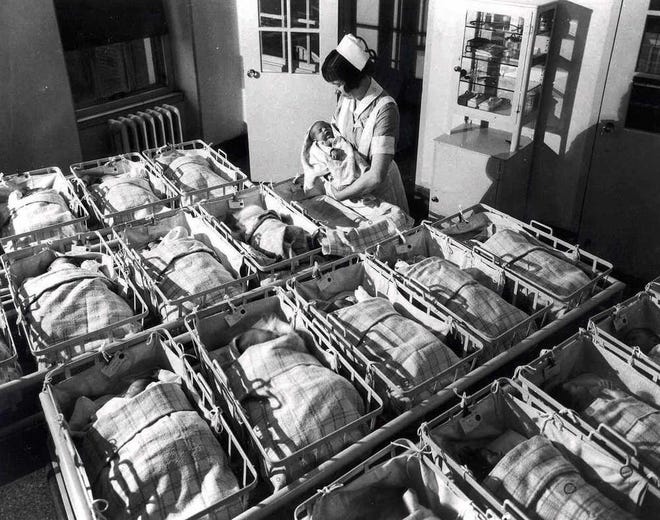 In this 1930 file photo, a nurse holds a baby in the nursery of the Pennsylvania Hospital in Philadelphia. Every year, slightly more boy babies than girl babies are born. But back when sperm meets egg, the two sexes are conceived in equal numbers, according to a new study released on Monday, March 30.