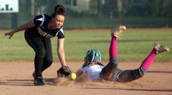 Shelby’s Taylor Newton reaches for the ball as Crest’s Jenna Wacaster dives for second during their game at Crest High School on Tuesday.