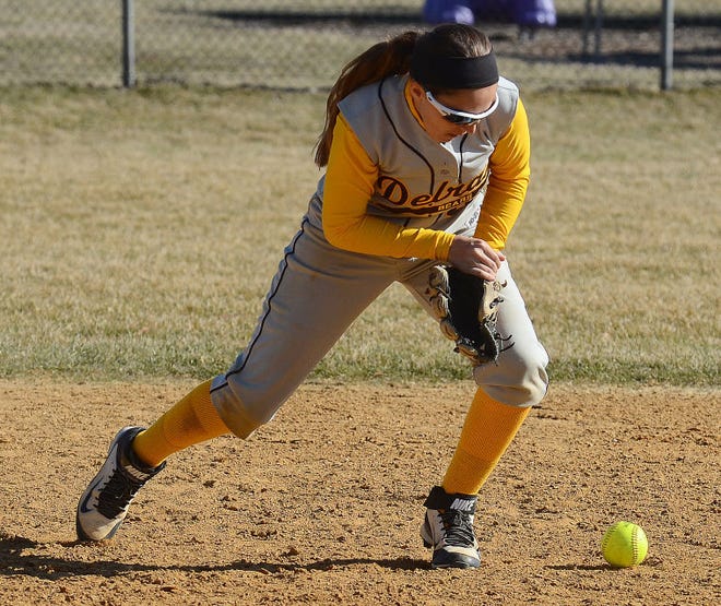 Fifth inning varsity softball action Wednesday April 1. 2015 had Delran's 3 Christina Arroya fielding a base hit by Riverside's 13 Emily Hubbs who was safe at first.