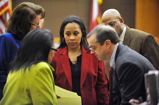 Prosecutors Linda Dunikoski, from left, Fani Willis, John Floyd and Clint Rucker check over a question from the jury regarding the indictment against former Atlanta Public Schools SRT Director Sharon Davis Williams during the Atlanta Public Schools test-cheating trial in Fulton County Superior Court, Thursday, March 19, 2015, in Atlanta. Jurors have begun deliberations in the trial a dozen former Atlanta Public Schools educators accused of participating in a test cheating conspiracy.