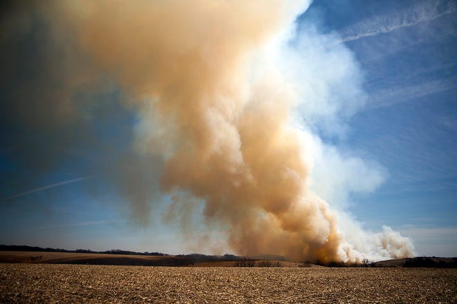 Plumes of smoke rise from a burning field east of U.S.150 and north of Henderson on Wednesday afternoon. Firefighters from Rio, Henderson and several other departments were on the scene attempting to extinguish the blaze. STEVE DAVIS/The Register-Mail
