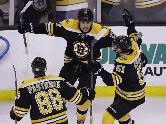 Boston Bruins left wing Milan Lucic, center, celebrates his go-ahead goal against the Florida Panthers with teammates David Pastrnak and Ryan Spooner during the third period of the game Tuesday, March 31, 2015.