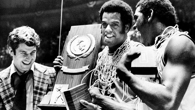 Indiana coach Bobby Knight, left, and team members Scott May, center, and Quinn Buckner right, celebrate with the trophy after winning the NCAA Basketball Championship in Philadelphia on March 30, 1976. They beat Michigan 86-68. Buckner and his 1975-76 Indiana teammates don’t plan on celebrating if their reign as college basketball’s last undefeated team continues. Instead, the Hoosiers have waited 39 years to welcome another undefeated national champion if Kentucky goes 40-0. (AP Photo, File)