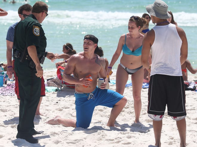 BCSO Lt. James Vestal informs Spring breakers about the new alcohol ban on sandy beaches. Law enforcement started enforcing the ban on sandy beaches in Panama City Beach on Wednesday.