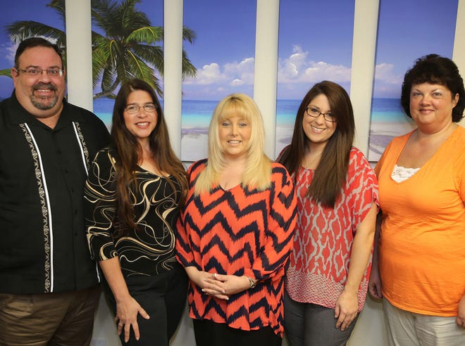 From left, Allen Herman, Danielle Streichert, Sherrie Creel, Amber Ecker and Julie Blankenship are seen at Emerald Coast Insurance Services in Panama City on Tuesday.