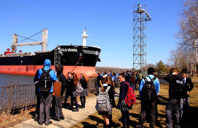 The 33,044-ton cargo ship Agia Irini rests at the shore near Doane Academy and the Burlington City Promenade on Wednesday as academy students look on.