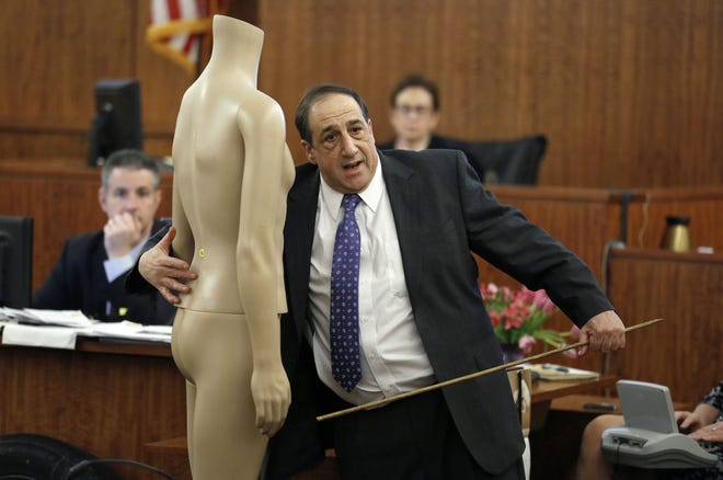 William Zane, of the state medical examiner's office, points to a mannequin, while testifying about the location of bullet wounds in the body of victim Odin Lloyd during the murder trial for former New England Patriots NFL football player Aaron Hernandez, Thursday, in Fall River. AP Pool Photo/Steven Senne