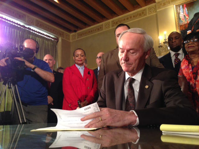 JOHN LYON • ARKANSAS NEWS BUREAU / Gov. Asa Hutchinson signs Senate Bill 975, a new religious-objection bill, on Thursday, April 2, 2015, a day after telling lawmakers that a previous bill on the same topic, House Bill 1228, was too broad. 
 JOHN LYON • ARKANSAS NEWS BUREAU / State Rep. Bob Ballinger, R-Hindsville, presents a new religious-objection bill in a House committee Thursday, April 2, 2015, a day after Gov. Hutchinson said Ballinger's previous bill on the topic was too broad.
