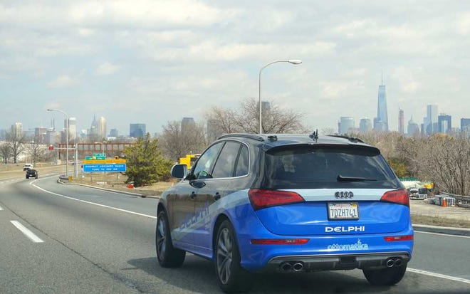 In this Monday, March 30, 2015 photo provided by Delphi Corp., the company's autonomous car approaches New York City, its final destination of a 3,400-mile road trip across the U.S., near Jersey City, N.J. Ninety-nine percent of the time, the car steered itself; only in very tricky situations, like a construction zone, did drivers take control. Now engineers will take the reams of data from the trip and use it to further advance autonomous technology. (AP Photo/Delphi Corp.)