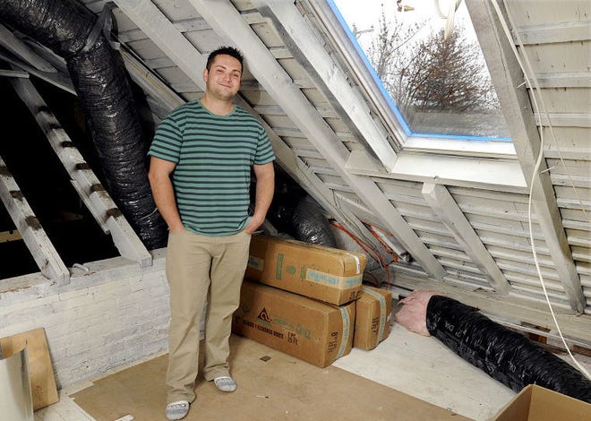 Justin Truelove in the unfinished attic of the Dublin home he is renovating with the help of an FHA loan.