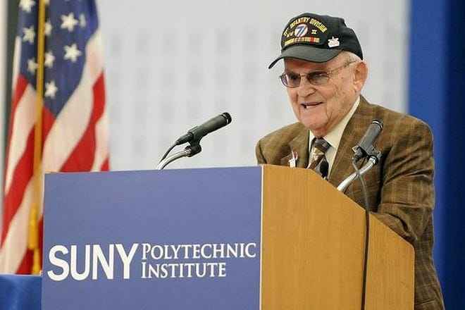 World War II veteran Alan Moskin speaks about his experience serving in the United States Army during the World War II Remembrance Day event at SUNY Polytechnic Institute in Marcy Thursday. “It (the war) left a mark on my soul, my heart,” he said. “How did this happen? Why did this happen? How did the civilized world let something like this happen?” GATEHOUSE NEW YORK PHOTO/TINA RUSSELL