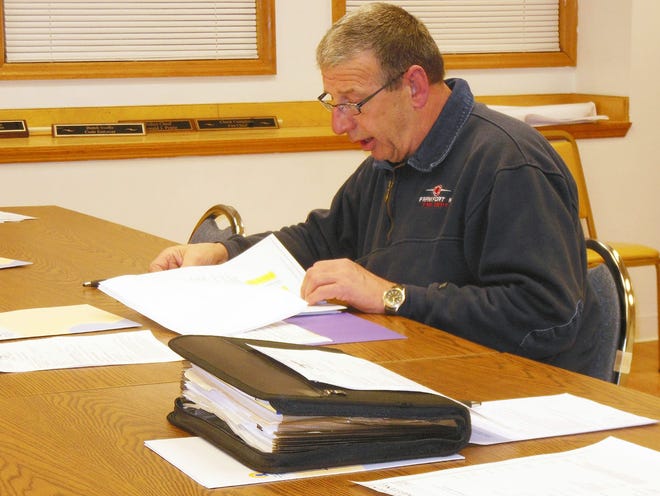 Frankfort Fire Chief Charles Conigliaro reviews an Insurance Service Organization's report on the village of Frankfort's public protection classification rating during a meeting Thursday. TELEGRAM PHOTO/DONNA THOMPSON