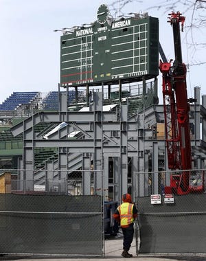 Construction continues on renovations to Wrigley Field's right-field bleachers in Chicago as it will on the facility through much of the season. THE ASSOCIATED PRESS
