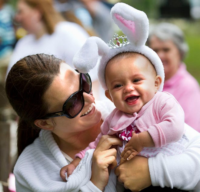 In this file photo, Lisa Griffith, left, gets her daughter Sumayah Griffith, 9-months-old, right, to giggle while the two attended the 15th Annual Eggstravaganza Saturday morning, April 19, 2014, at Tuscawilla Park. The event catered to infants up to 10 years-old with about 2000 children attending the event.