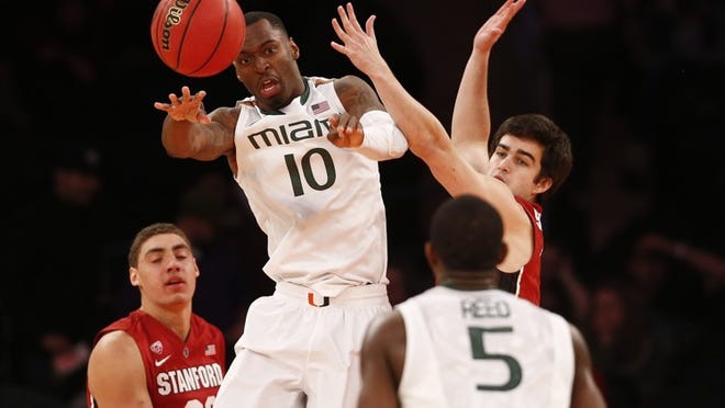 NEW YORK, NY - APRIL 02: Sheldon McClellan #10 of the Miami Hurricanes passes in front of Christian Sanders #1 of the Stanford Cardinal during the NIT Championship at Madison Square Garden on April 2, 2015 in New York City. (Photo by Jeff Zelevansky/Getty Images)