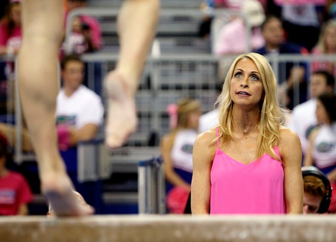 Florida Gators head coach Rhonda Faehn watches a gymnast warm up on the beam during the ninth annual Link to Pink meet against the Kentucky Wildcats on Friday, Feb. 27, 2015 in Gainesville, Florida. Florida defeated Kentucky 198.125 to 195.950.