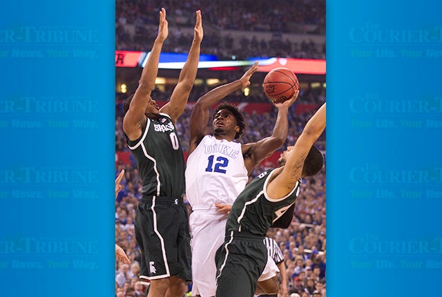Duke's Justise Winslow (12) puts up a shot against Michigan State's Marvin Clark Jr. (0) during the first half in the NCAA Tournament national semifinal at Lucas Oil Stadium in Indianapolis on Saturday, April 4, 2015. Duke advanced, 81-61. (Robert Willett/Raleigh News & Observer/TNS)