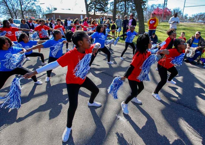 The Boys and Girls Club of Topeka dance in the street while participating in Saturday morning's Easter parade at Gage Park.