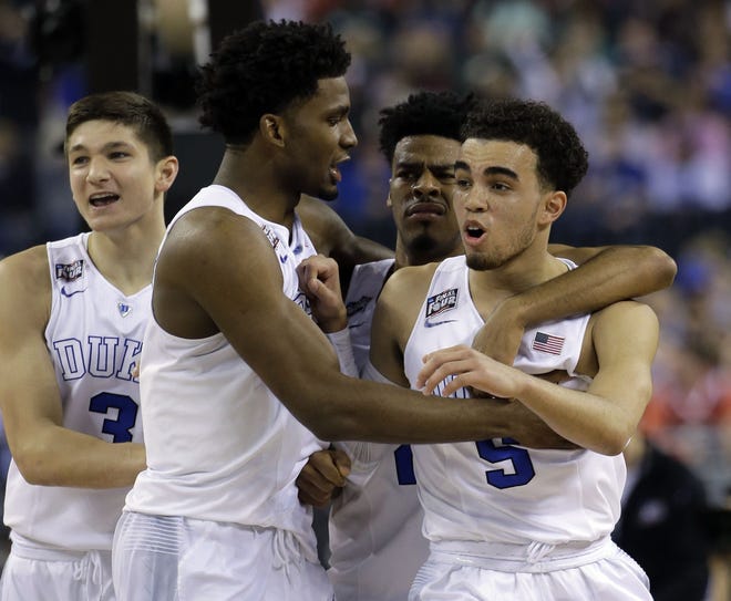 Duke's Tyus Jones, right, reacts with Grayson Allen, Justise Winslow and Quinn Cook during the first half of the NCAA Final Four tournament college basketball semifinal game against Michigan State Saturday, April 4, 2015, in Indianapolis. (AP Photo/David J. Phillip)