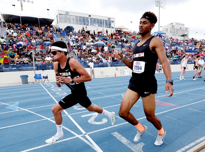 Florida's Najee Glass passes the baton to teammate Andres Arroyo for the final leg of the mens 1600 sprint medley during the final day of the Florida Relays on Saturday in Gainesville.