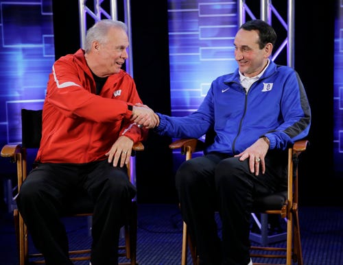 Wisconsin head coach Bo Ryan and Duke head coach Mike Krzyzewski shake hands during a CBS Sports interview for the NCAA Final Four college basketball tournament championship game Sunday, April 5, 2015, in Indianapolis.