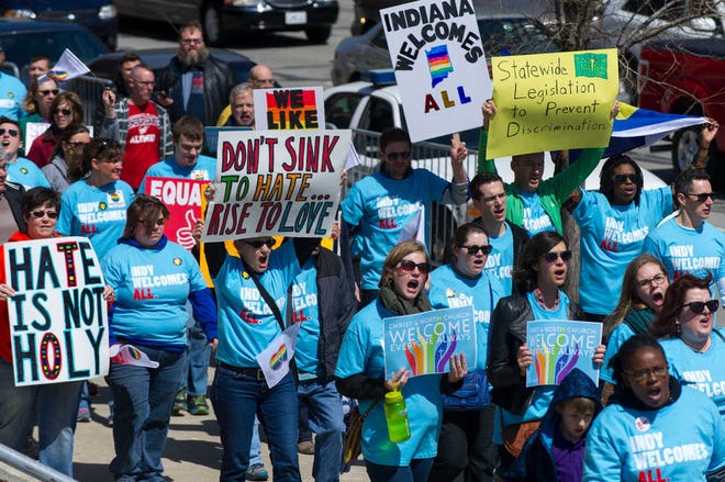 Opponents of Indiana Senate Bill 101, the Religious Freedom Restoration Act, march towards Lucas Oil Stadium in Indianapolis on Saturday, April 4, 2015 to push for a state law that specifically bars discrimination based on sexual orientation or gender identity. (AP Photo/Doug McSchooler)