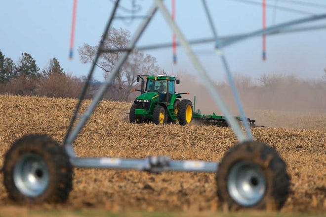 A farmer tills a field near Mead, Neb., Monday, March 30, 2015. The USDA releases its annual prospective planting report on Tuesday, March 31, 2015, which outlines farmer decisions about how much land to dedicate to corn, soybeans and other major crops including wheat and cotton. (AP Photo/Nati Harnik)