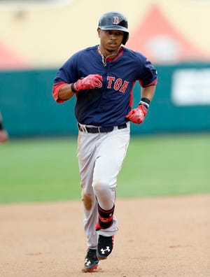 Boston Red Sox' Mookie Betts rounds the bases after his two-run home run during the fourth inning of a spring training exhibition baseball game against the Atlanta Braves in Kissimmee, Fla., Friday, March 27, 2015.
