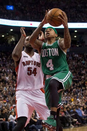 Boston Celtics' Isaiah Thomas goes to the basket against Toronto Raptors' Patrick Patterson during the second half of an NBA basketball game Saturday, April 4, 2015, in Toronto. The Celtics won 117-116 in overtime. (AP Photo/The Canadian Press, Chris Young)