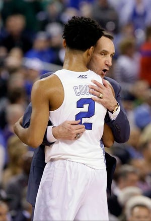 Duke head coach Mike Krzyzewski hugs Quinn Cook during the second half of the NCAA Final Four tournament college basketball semifinal game against Michigan State Saturday, April 4, 2015, in Indianapolis. Duke won 81-61.(AP Photo/Charlie Neibergall)