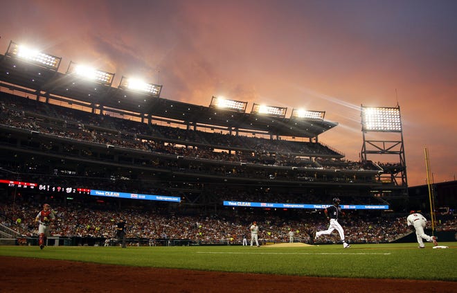 The sky glows over Nationals Park as the sun sets during the fourth inning of a 2012 game between the Washington Nationals and Philadelphia Phillies. AP File Photo/Carolyn Kaster