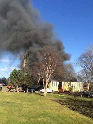 Four fire departments were battling a garage fire about 6 p.m. at 101 E. Main St. in Limaville, a RED Center dispatcher said.