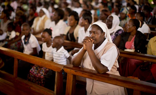 A nun prays during the service at the Our Lady of Consolation Church, which was attacked with grenades by militants almost three years ago, in Garissa, Kenya Sunday, April 5, 2015. Easter Sunday's ceremony was laden with emotion for the several hundred members of Garissa's Christian minority, which is fearful following the recent attack on Garissa University College by al-Shabab, a Somalia-based Islamic extremist group, who singled out Christians for killing, though al-Shabab has a long record of killing Muslims over the years. (AP Photo/Ben Curtis)