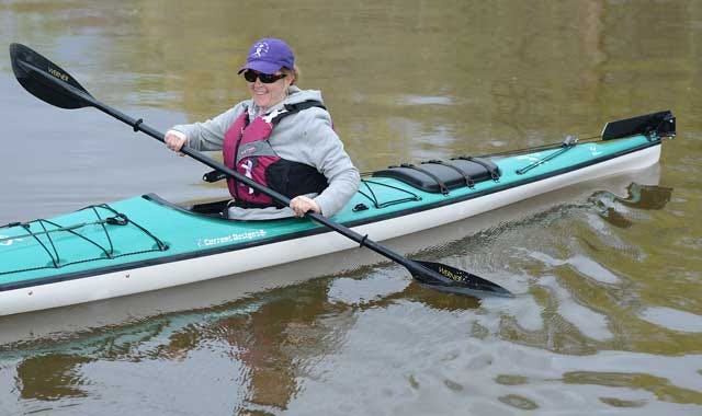 Kim Tart paddles from the Cox Ferry Landing in Wayne County off Ferry Bridge Road on Monday as she and her team of kayakers continue their journey down the Neuse River to Kinston on the Grand Slam Tour of Hope Floats N.C. to raise money for cancer research.