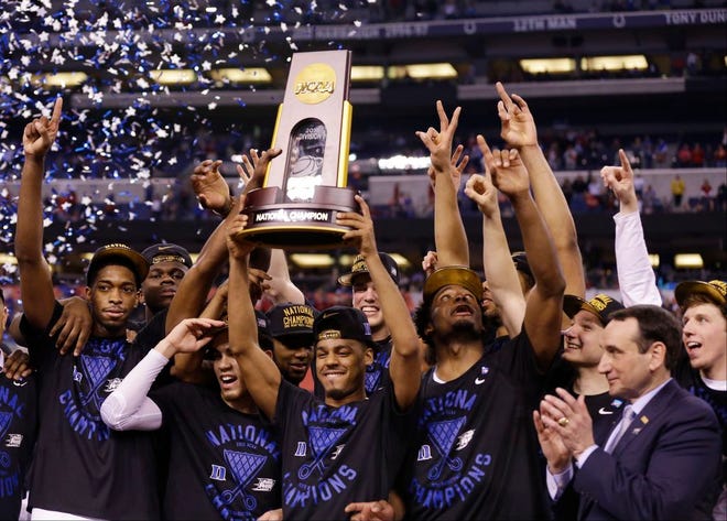 Duke players celebrate with the trophy after their 68-63 victory over Wisconsin in the NCAA tournament championship game Monday in Indianapolis.