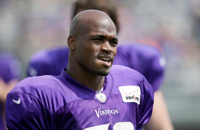 FILE - This July 31, 2014, file photo shows Minnesota Vikings running back Adrian Peterson during NFL football training camp in Mankato, Minn. A person with knowledge of the situation tells The Associated Press that Vikings running back Adrian Peterson will meet with the NFL on Tuesday, April 7, 2015, to discuss his playing status. The person spoke Monday to the AP on condition of anonymity because of the sensitivity of the information. (AP Photo/Charlie Neibergall, File)