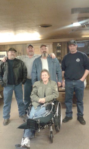 Legion Riders pose for a photo with Vicky Strange, wife of one of the members, who had her leg amputated due to blood clots.
