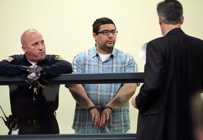 Carlos Colina, center, speaks with his attorney John Cunha, Jr., right, during his arraignment in Cambridge District Court in Medford, Mass., Monday, April 6, 2015. Colina was charged with being an accessory after the crime of assault and battery causing serious bodily injury and the improper disposal of human remains, after the discovery of human remains in Cambridge on Saturday. (AP Pool Photo)