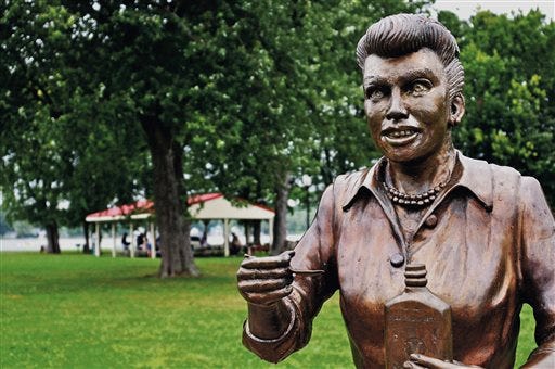 In an August 2012 photo, a bronze sculpture of Lucille Ball is displayed in Lucille Ball Memorial Park in the village of Celoron, N.Y., in her hometown. Since the sculpture was unveiled in 2009, the statue has been blasted by critics who say it bears little or no likeness to the popular 1950s sitcom actress and comedian. Village officials say they want the sculptor to fix it for free, but the artist wants as much as $10,000 to alter the statue. The village has started a fundraising effort to pay for the sculpture's makeover. (AP Photo/The Post-Journal)