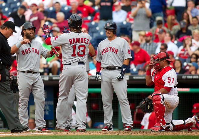 Boston Red Sox Hanley Ramirez celebrates his grand slam to left field on opening day against the Phillies at Citizens Bank Park in Philadelphia Monday, April 6, 2015. He drove in Napoli, Betts and Craig (seen here left to right).