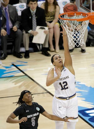 Notre Dame forward Taya Reimer (12) shoots against South Carolina guard Khadijah Sessions (5) during the second half of the NCAA Women's Final Four tournament college basketball semifinal game, Sunday, April 5, 2015, in Tampa, Fla. Notre Dame won 66-65. (AP Photo/Chris O'Meara)