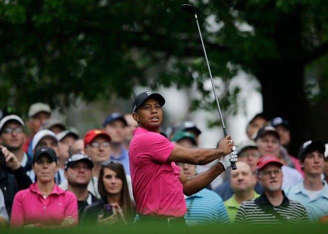 Tiger Woods watches his tee shot on the fourth hole during a practice round for the Masters golf tournament Tuesday, April 7, 2015, in Augusta, Ga. (AP Photo/Matt Slocum)