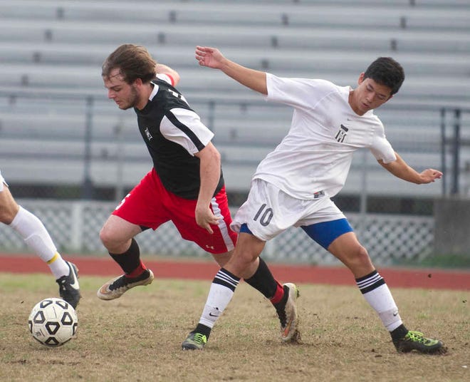Harlem's Ryan Sherman (left) and Evans' Nathan Pak battle for control of the ball. Photo by Jim Blaylock