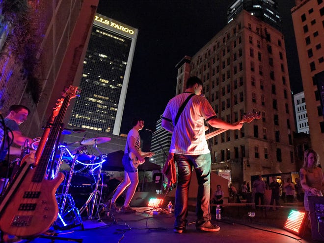 Members of the band Gov Club perform on the stage of the Trio Lot on Wednesday night. One Spark 2015 got underway in downtown Jacksonville with creators setting up their displays and starting their pitches in an attempt to get a piece of the available crowd sourced money.