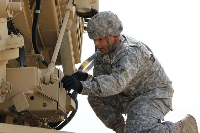 Spc. Josh Berrong, a Patriot launching station enhanced operator and maintainer, assigned to Battery D, 1st Battalion, 7th Air Defense Artillery Regiment, 108th Air Defense Artillery Brigade, checks the status of parts on the Patriot missile launcher while calling out what he is doing to his teammates in Southwest Asia, March 25. Patriot assumption drills, like the one Berrong and his team conducted, ensure the success of their operational readiness exercises and the overall Patriot readiness of the Army.